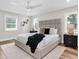 Spacious main bedroom with ample natural light, a ceiling fan, and elegant decor at 18102 Spencer Rd, Odessa, FL 33556