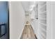 Spacious walk-in closet with custom shelving and hanging racks for optimal storage at 18102 Spencer Rd, Odessa, FL 33556