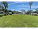 Spacious, lush yard with a trailer and partial home view under a bright sky at 18102 Spencer Rd, Odessa, FL 33556