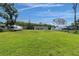 Expansive green lawn leading to a charming home with large backyard at 18102 Spencer Rd, Odessa, FL 33556