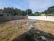 Large backyard with fire pit and colorful Adirondack chairs at 2004 Culberson Ave, Dunedin, FL 34698