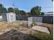 Fenced backyard featuring shed, landscaping, and ample space at 2004 Culberson Ave, Dunedin, FL 34698