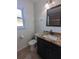 Stylish bathroom with granite countertop vanity, white wainscoting, and modern fixtures at 2004 Culberson Ave, Dunedin, FL 34698