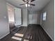 Spacious bedroom with ceiling fan, wood floors, closet, window and staircase to another room at 2004 Culberson Ave, Dunedin, FL 34698