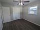 Bright bedroom features wood-look floors, modern ceiling fan, and closet at 2004 Culberson Ave, Dunedin, FL 34698