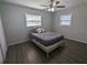 Bedroom with natural light featuring modern ceiling fan and wood-look flooring at 2004 Culberson Ave, Dunedin, FL 34698