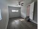 Cozy bedroom with modern flooring, a ceiling fan, and a door leading to another room at 2004 Culberson Ave, Dunedin, FL 34698