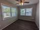 Cozy bedroom filled with natural light from the two windows overlooking backyard at 2004 Culberson Ave, Dunedin, FL 34698