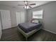 Well lit bedroom features natural light, ceiling fan, and wood-look flooring at 2004 Culberson Ave, Dunedin, FL 34698