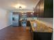 Kitchen featuring stainless steel appliances, dark wood cabinets, and granite countertops at 2004 Culberson Ave, Dunedin, FL 34698
