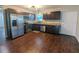 Modern kitchen with stainless steel appliances, dark wood cabinets, and a stylish backsplash at 2004 Culberson Ave, Dunedin, FL 34698