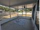 The screened patio features a ceiling fan and access to the backyard at 2004 Culberson Ave, Dunedin, FL 34698