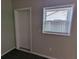 Neutral room showing a window, wood floors, white door and simple design at 2004 Culberson Ave, Dunedin, FL 34698