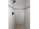 Modern shower stall with decorative tile accent, neutral wall tile, and dark hardware at 2004 Culberson Ave, Dunedin, FL 34698