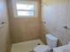 Tiled bathroom features a shower and neutral color palette, offering a clean and functional space at 2051 Peggy Dr, Holiday, FL 34690