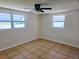 Bedroom with tile floors and natural light from two windows creates a cozy retreat at 2051 Peggy Dr, Holiday, FL 34690