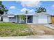 Charming single-story home with a well-maintained lawn and an attached garage, perfect for first-time buyers at 2051 Peggy Dr, Holiday, FL 34690