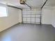 Spacious garage with gray epoxy floor and white garage door at 2051 Peggy Dr, Holiday, FL 34690
