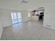 Living room with tile floor, open to the kitchen and sunroom at 2051 Peggy Dr, Holiday, FL 34690