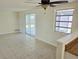 Bright living room featuring tile floors and sliding door to screened in lanai at 2051 Peggy Dr, Holiday, FL 34690