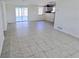 Spacious living room features tile flooring, and leads to porch and kitchen at 2051 Peggy Dr, Holiday, FL 34690