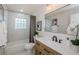 Bathroom featuring a modern vanity, tiled shower-tub, and elegant fixtures at 22154 Weeks Blvd, Land O Lakes, FL 34639