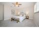 Bright bedroom with a ceiling fan, soft carpet, a bench, and decor at 22154 Weeks Blvd, Land O Lakes, FL 34639