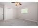 Bright bedroom featuring a ceiling fan, a window, and closet at 22154 Weeks Blvd, Land O Lakes, FL 34639