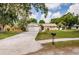Charming home with a well-maintained front yard, featuring a long driveway and lush landscaping at 22154 Weeks Blvd, Land O Lakes, FL 34639
