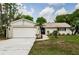 Charming single-story home featuring a two-car garage, well-maintained lawn, and inviting front entrance at 22154 Weeks Blvd, Land O Lakes, FL 34639