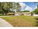 Spacious front yard showcasing a well-maintained lawn and the home's charming single-story exterior at 22154 Weeks Blvd, Land O Lakes, FL 34639