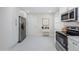 Spacious kitchen with stainless steel appliances, white cabinets, and marble floors at 22154 Weeks Blvd, Land O Lakes, FL 34639