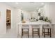 Bright kitchen with white cabinets, marble countertops, island with seating, and stainless steel appliances at 22154 Weeks Blvd, Land O Lakes, FL 34639