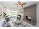 Living room with a stone fireplace and sliding glass doors leading to the pool at 22154 Weeks Blvd, Land O Lakes, FL 34639