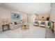 Living room features a sofa with blue pillows, chairs, and a view of the dining room at 22154 Weeks Blvd, Land O Lakes, FL 34639