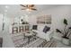 Bright living room with kitchen, white sofa, area rug and indoor plant at 22154 Weeks Blvd, Land O Lakes, FL 34639