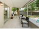 Inviting covered patio with comfortable seating, next to the pool and backyard at 22154 Weeks Blvd, Land O Lakes, FL 34639