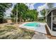 Backyard pool surrounded by lush landscaping offering a private oasis at 22154 Weeks Blvd, Land O Lakes, FL 34639
