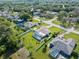 This aerial view features homes in a well-established neighborhood with mature trees and private backyard pools at 2585 Waterfall Dr, Spring Hill, FL 34608