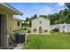 Spacious backyard with a shed, plants, and white picket fence, creating a peaceful outdoor retreat at 2585 Waterfall Dr, Spring Hill, FL 34608