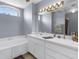 Well-lit bathroom with a bathtub, and large vanity with a well-lit mirror at 2585 Waterfall Dr, Spring Hill, FL 34608