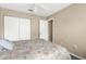 Comfortable bedroom features floral bedding, closet space and adjacent door, and ceiling fan at 2585 Waterfall Dr, Spring Hill, FL 34608