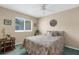 Inviting bedroom featuring a bed with floral comforter, ceiling fan, and ample natural light at 2585 Waterfall Dr, Spring Hill, FL 34608