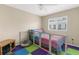 Cozy bedroom featuring playful decor, colorful flooring, and a ceiling fan for added comfort at 2585 Waterfall Dr, Spring Hill, FL 34608
