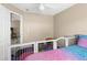 Bright bedroom featuring playful decor, colorful flooring, and a ceiling fan for added comfort at 2585 Waterfall Dr, Spring Hill, FL 34608