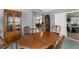 Traditional dining room features wood table and chairs, matching hutch, and sliding doors to Florida room at 2585 Waterfall Dr, Spring Hill, FL 34608