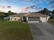 Charming single-story home with a well-manicured lawn, screened garage, and inviting curb appeal at 2585 Waterfall Dr, Spring Hill, FL 34608
