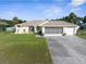 Charming single-story home with a well-maintained lawn, beautiful landscaping, and a two car garage at 2585 Waterfall Dr, Spring Hill, FL 34608