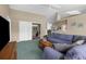 Comfortable living room with ample seating, center table, ceiling fan, and sliding doors leading to an outdoor area at 2585 Waterfall Dr, Spring Hill, FL 34608