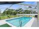 Sparkling in-ground pool with screened enclosure and ample deck space for outdoor enjoyment at 2585 Waterfall Dr, Spring Hill, FL 34608